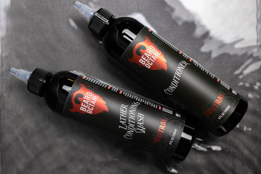 Unscented neutral range beard octane conditioner bottles with black packaging and logo, designed for men's grooming, on a gray surface.